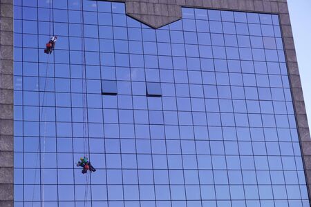industrial climbing, cleaning of Windows, glass elements of building. maintenance of skyscrapers. hard workの写真素材