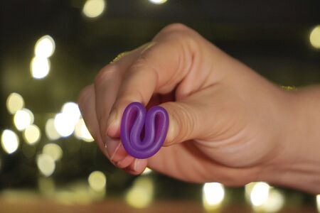 menstrual Cup on red or black background in girl hand, low key. woman hands folding a menstrual cup. lights in the background.zero waste, reusable female supplies, copy space.menstrual protectionの写真素材