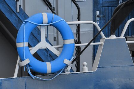 blue is color of the year, a lifebuoy hanging on the railing of a yacht or ship. help people in difficult situations - if it is impossible to swim out on their own.の写真素材