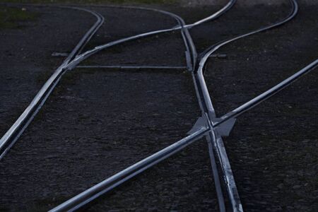 bending rails in the city on street with paving stones. network for trams, public transport, urban communications. background screensaver, copy space for textの写真素材