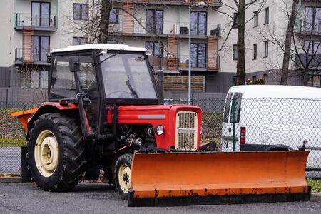 Krakow, Poland 12.24.2019: new tractor parked is waiting for winter and snow for cleaning on the roads, clearing snow. unexpected winter, Tinker's day.のeditorial素材