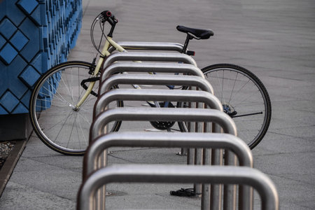 One old bike is fixed to a metal structure for Parking bicycles or scooters, environmental transport...