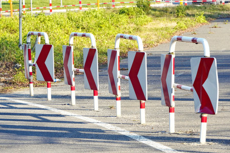 Red and white metal construction of the road fence on the edge of the roadway. Road infrastructure,...