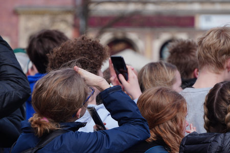 A lot of people are looking up and taking pictures on mobile phone cameras.
