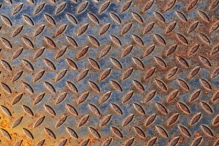 Background of rusty metal material texture with pattern, used. distressed enamel metal surface. Weathered steel rust.の写真素材