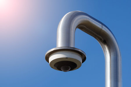 white CCTV dome camera on the street, security in city. covert shooting of what is happening. modern...