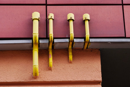 Yellow gas pipes on the front of the house. The danger of gas