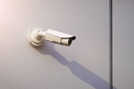 Camera CCTV on the facade of a modern office building on the street, security in the city. Covert shooting of what is happening. modern technologies and equipments.の写真素材