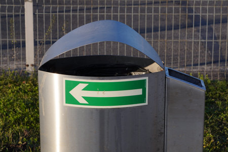 metal urn for mixed garbage and cigarette butts on street of the city. separate collection of waste