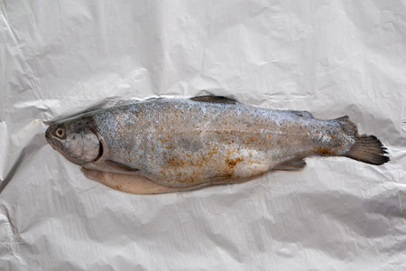 Cooking fish-mountain trout, baking in a foil. Home-cooked food, Hobbies. Roasted trout