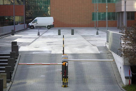 Empty parking lot in European city. No people on the street. Low number of cars on the road....