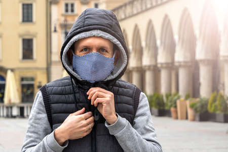 Cracow, Poland 05.03.2020: People walk in medical masks on Central square to Krakow. Empty square, social distancing of tourists. Open the country after coronavirus and lockdown quarantineのeditorial素材