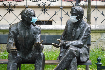 Otto Nikodym and Stefan Banach are sitting in medical masks on the Memorial bench quarantine...