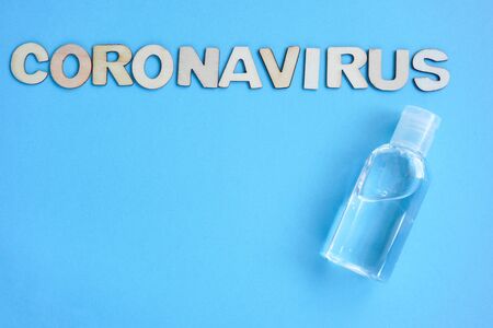 Antiseptic, Inscription coronavirus is made of wooden letters laid out on blue background. a blank with Copyspace. flatlay quarantine concept, Covid19, bacteria.の写真素材