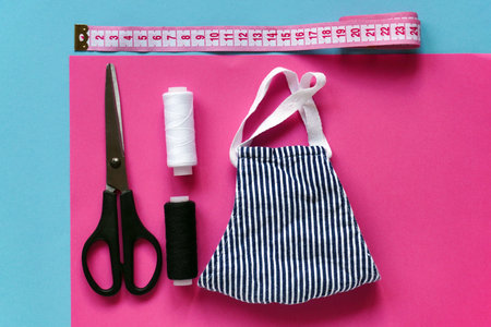 Sewing reusable and washable cotton mask during coronavirus or infection or allergy. Thread,...