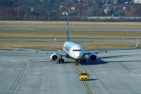 Krakow, Poland 20.12.2019: Ryanair Boeing 737-800 is at airport, preparing for flight. The service of the vessel flying before the flight. Fly to other countries, travel and business tripsのeditorial素材