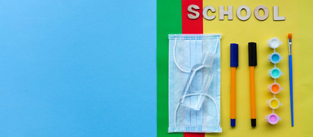Study flatlay concept. Education supplies-pencil,pen,brush, paint, medical mask and sanitizer paint...