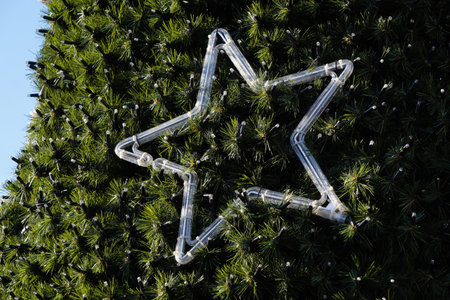 Christmas tree toys close-up on a city fir tree. Decorations of the city for the holidays new year. Christmas decorations and festive lights, magic of the holidayの写真素材