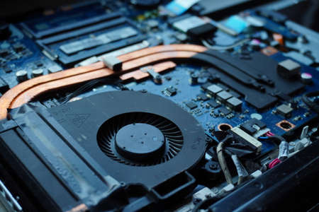 parts of a disassembled laptop from dust and dirty close up in workshop or repairing. Krakow, Poland 21.01.2020の写真素材