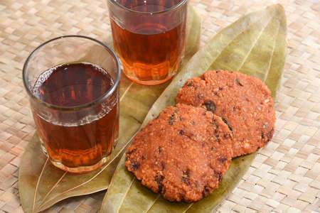 Parippu vada with Indian tea or Chai Kerala Snacks popular deep fried hot and spicy tea time food. Traditional food for Ramadan, Onam, Vishu in tamil nadu, Street food of India.の写真素材