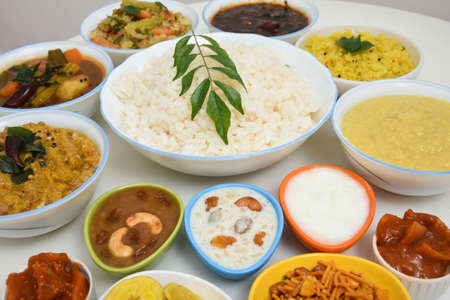 Onam Sadhya, traditional Indian lunch boiled rice served with many spicy hot curries and lots of sweet dessert for Kerala harvest festival in India.の写真素材