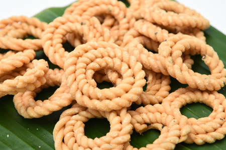 Kerala snack rice Murukku savory, Chakli, Chakali fried snack on banana leaf popular in South India Tamil Nadu, Top view Indian tea time food fried in coconut oil.の写真素材