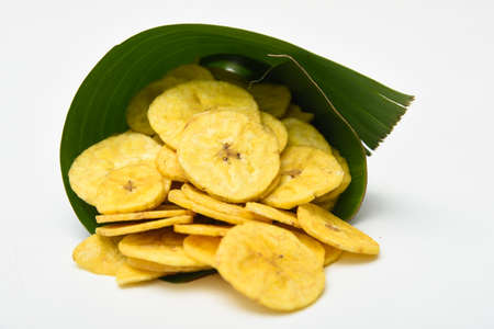 Kerala snack Banana chips or Kaya Varuthathu fried snack in in banana leaf popular in South India Tamil Nadu, Top view Indian tea time food fried in coconut oil.の写真素材