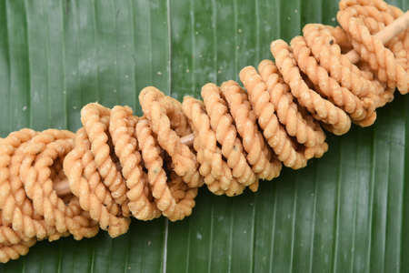 Kerala snack rice Murukku savory, Chakli, Chakali fried snack on banana leaf popular in South India Tamil Nadu, Top view Indian tea time food fried in coconut oil.の写真素材