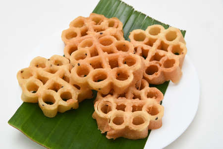 Kerala snack Achappam or rosette cookies fried snack on banana leaf popular in South India Tamil Nadu, Top view Indian tea time food fried in coconut oil.の写真素材