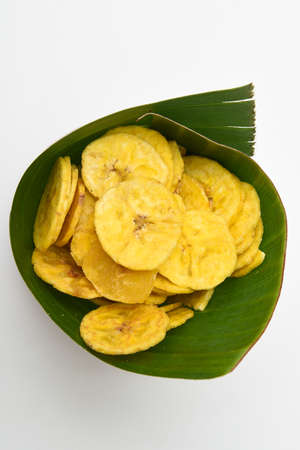 Kerala snack Banana chips or Kaya Varuthathu fried snack in in banana leaf popular in South India Tamil Nadu, Top view Indian tea time food fried in coconut oil.の写真素材