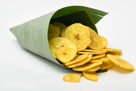 Kerala snack Banana chips or Kaya Varuthathu fried snack in in banana leaf popular in South India Tamil Nadu, Top view Indian tea time food fried in coconut oil.の写真素材