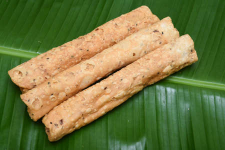 Kerala snack Kuzhalappam fried snack on banana leaf popular in South India Tamil Nadu, Top view Indian tea time food fried in coconut oil.の写真素材