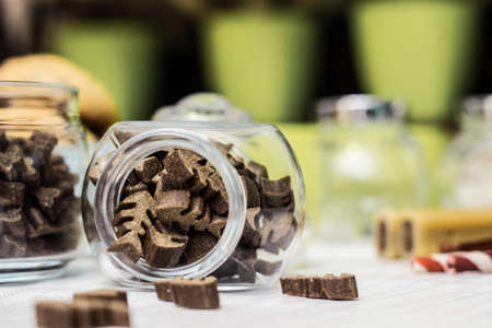 Dog treats spilling out of bowl. Dog treats and biscuitsの写真素材