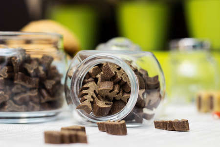 Dog treats spilling out of bowl. Dog treats and biscuitsの写真素材