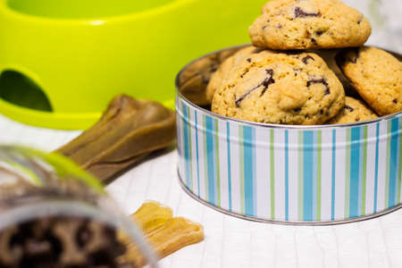Dog treats spilling out of bowl. Dog treats and biscuitsの写真素材