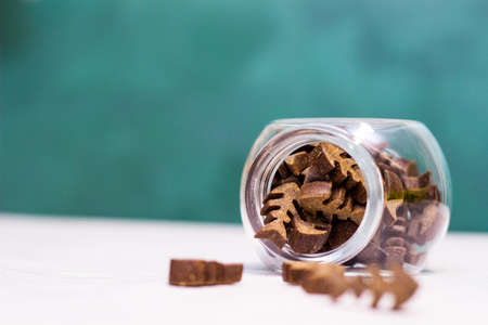 Dog treats spilling out of bowl. Dog treats and biscuitsの写真素材