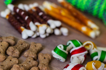 Dog tasty colored biscuits on wooden background, snacks for dogs. Healthy dry pet food conceptの写真素材