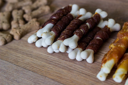 Dog tasty colored biscuits on wooden background, snacks for dogs. Healthy dry pet food conceptの写真素材