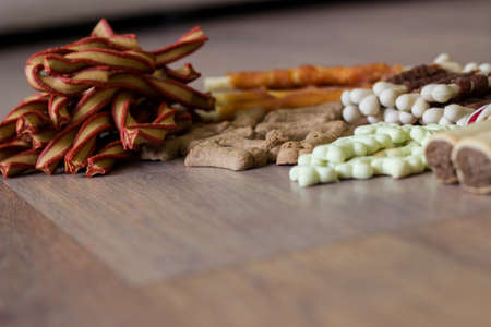 Dog tasty colored biscuits on wooden background, snacks for dogs. Healthy dry pet food conceptの写真素材