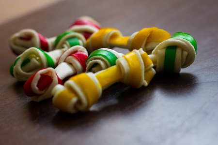 Dog tasty colored biscuits on wooden background, snacks for dogs. Healthy dry pet food concept