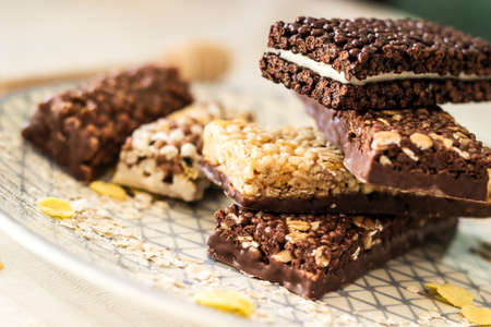 Granola energy bar with mix of nuts and fruits on a plateの写真素材