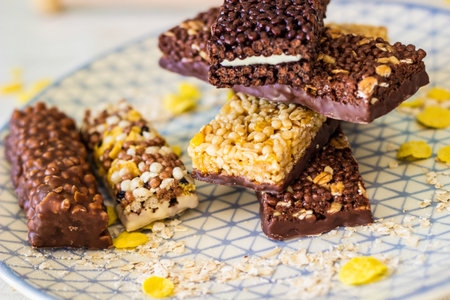 Granola energy bar with mix of nuts and fruits on a plate