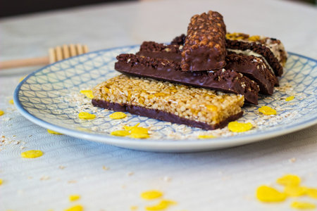Granola energy bar with mix of nuts and fruits on a plate