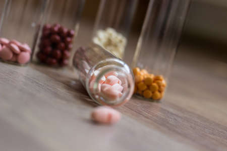 Medications and tablets on a wooden texture tableの写真素材