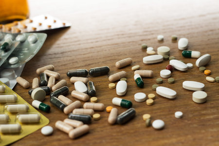 Medications and tablets on a wooden texture table
