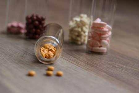 Medications and tablets on a wooden texture tableの写真素材