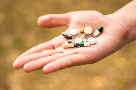 Various drugs in human hand. Prepared to take my nutritional supplements