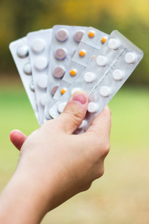 Various drugs in human hand. Prepared to take my nutritional supplements