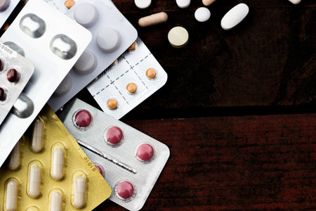 Medications and tablets on a wooden texture table