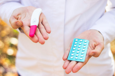 Woman doctor holding pregnancy pills and test